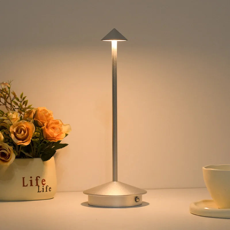 Rechargeable LED table lamp with touch control, white color, on a desk