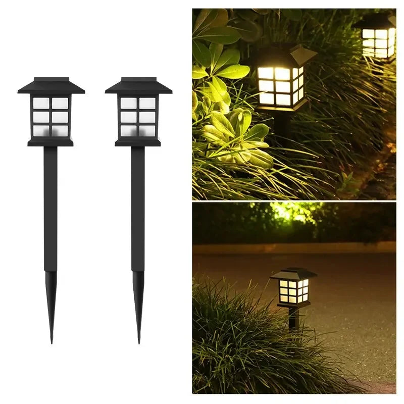 Two solar pathway lights illuminating a garden walkway at dusk