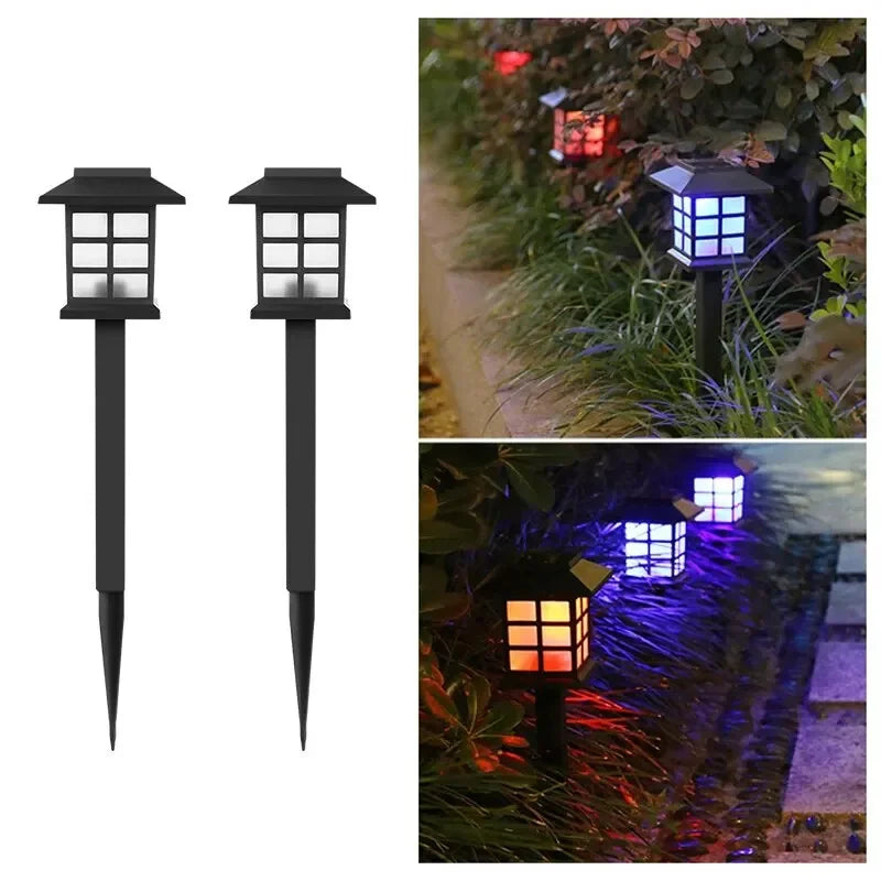 Two solar pathway lights illuminating a garden walkway at dusk