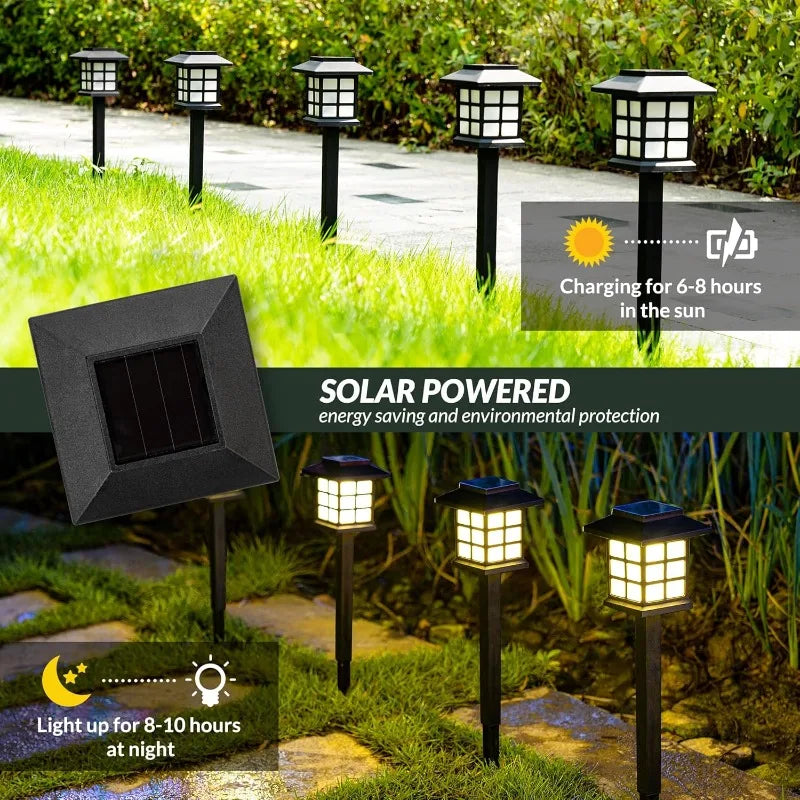 Two solar pathway lights illuminating a garden walkway at dusk